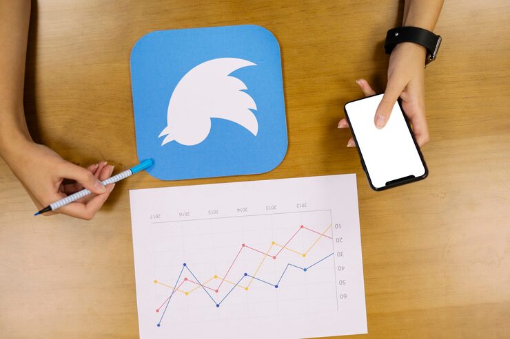 person holding mobile phone analyzing twitter graph 23 2147847487