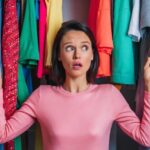 woman head sticking out through different multicolored clothes looks away with stunned expression 926199 2191067