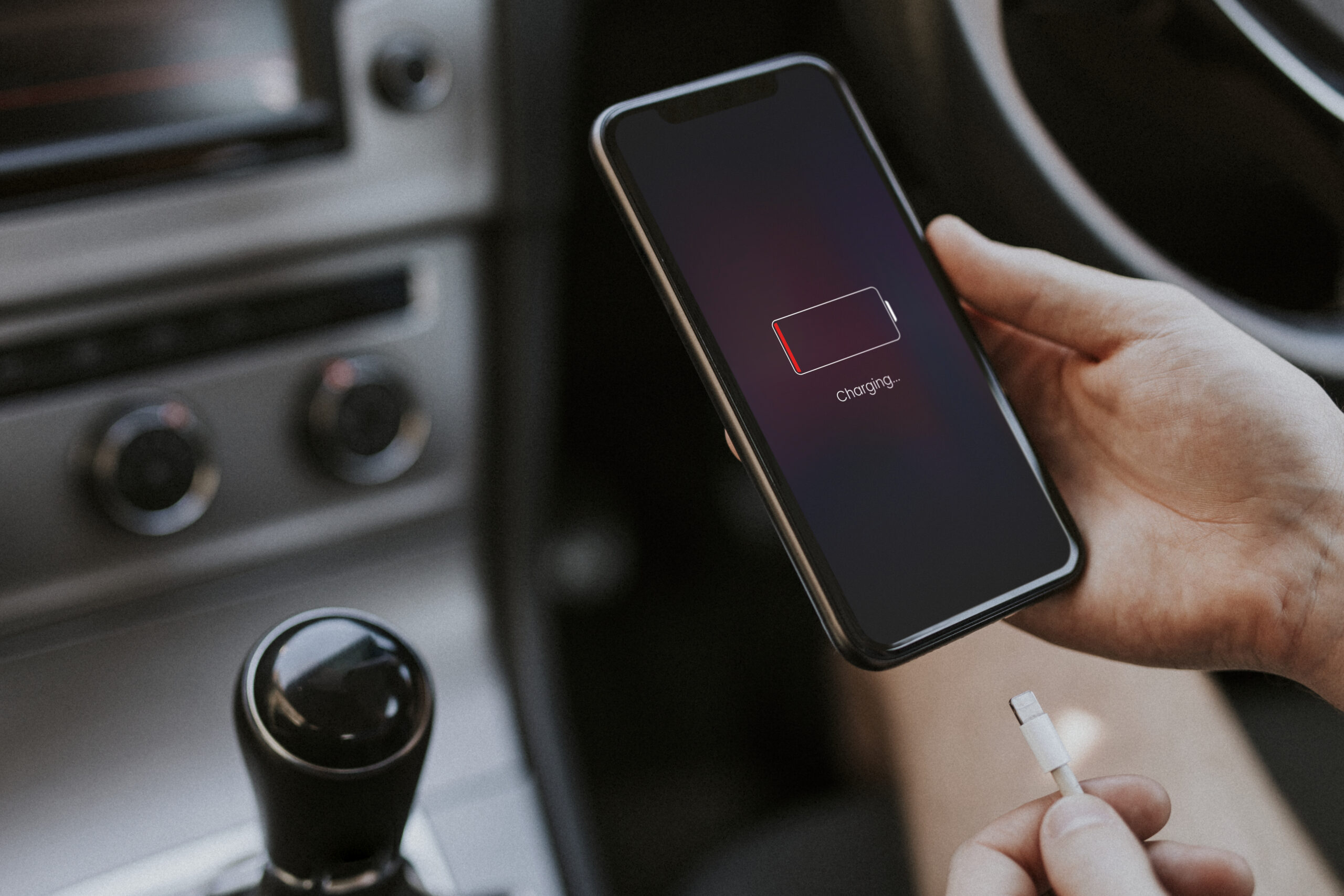 Smartphone connected to charger displaying slow charging notification