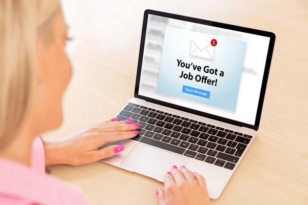 Fake job offer email displayed on a laptop screen